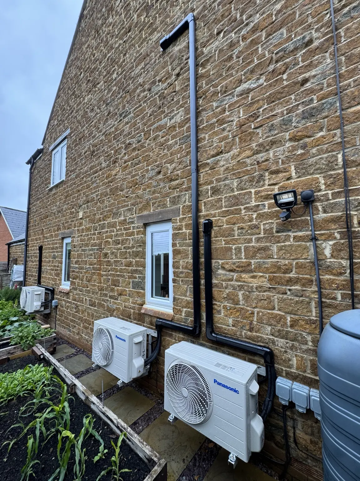 Multiple outdoor air conditioning units installed with carefully routed services
