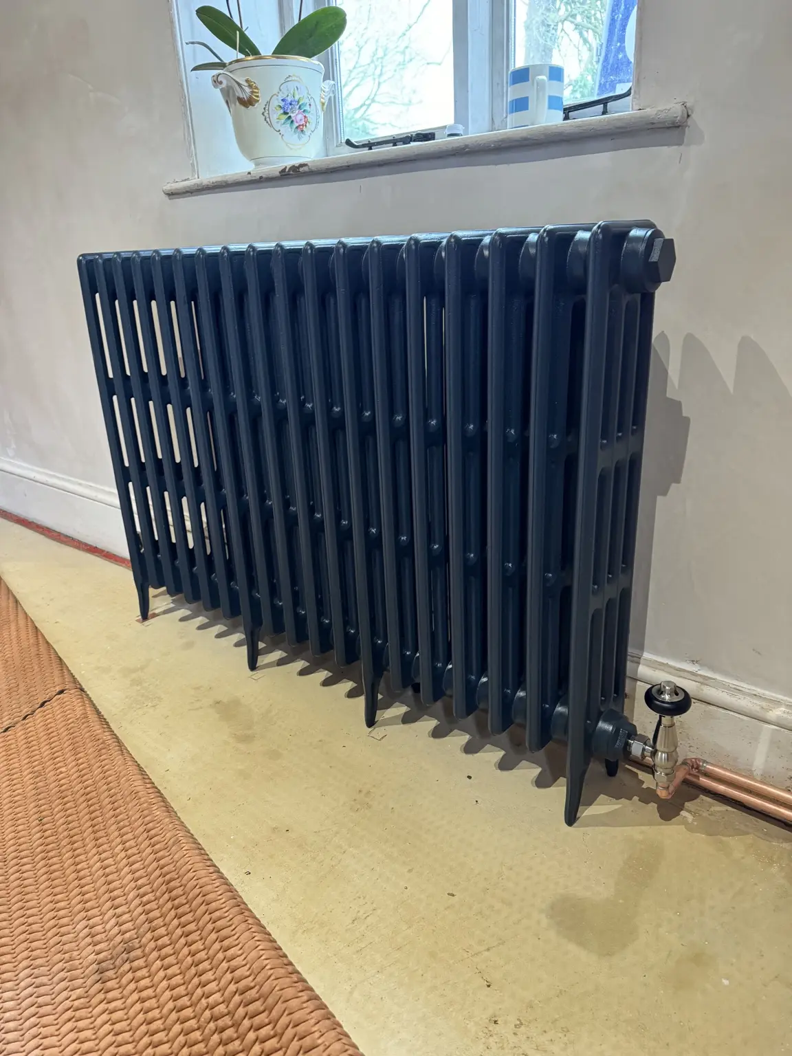 Black designer radiator installed by Gas Smart Heating & Cooling