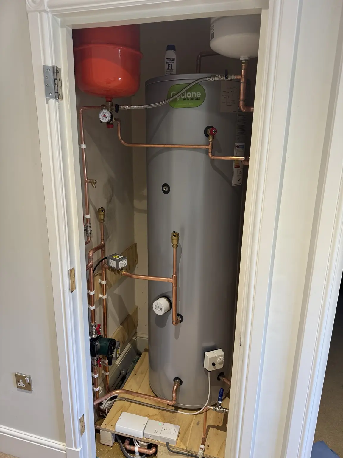 A separate unvented hot water cylinder installation in a cupboard